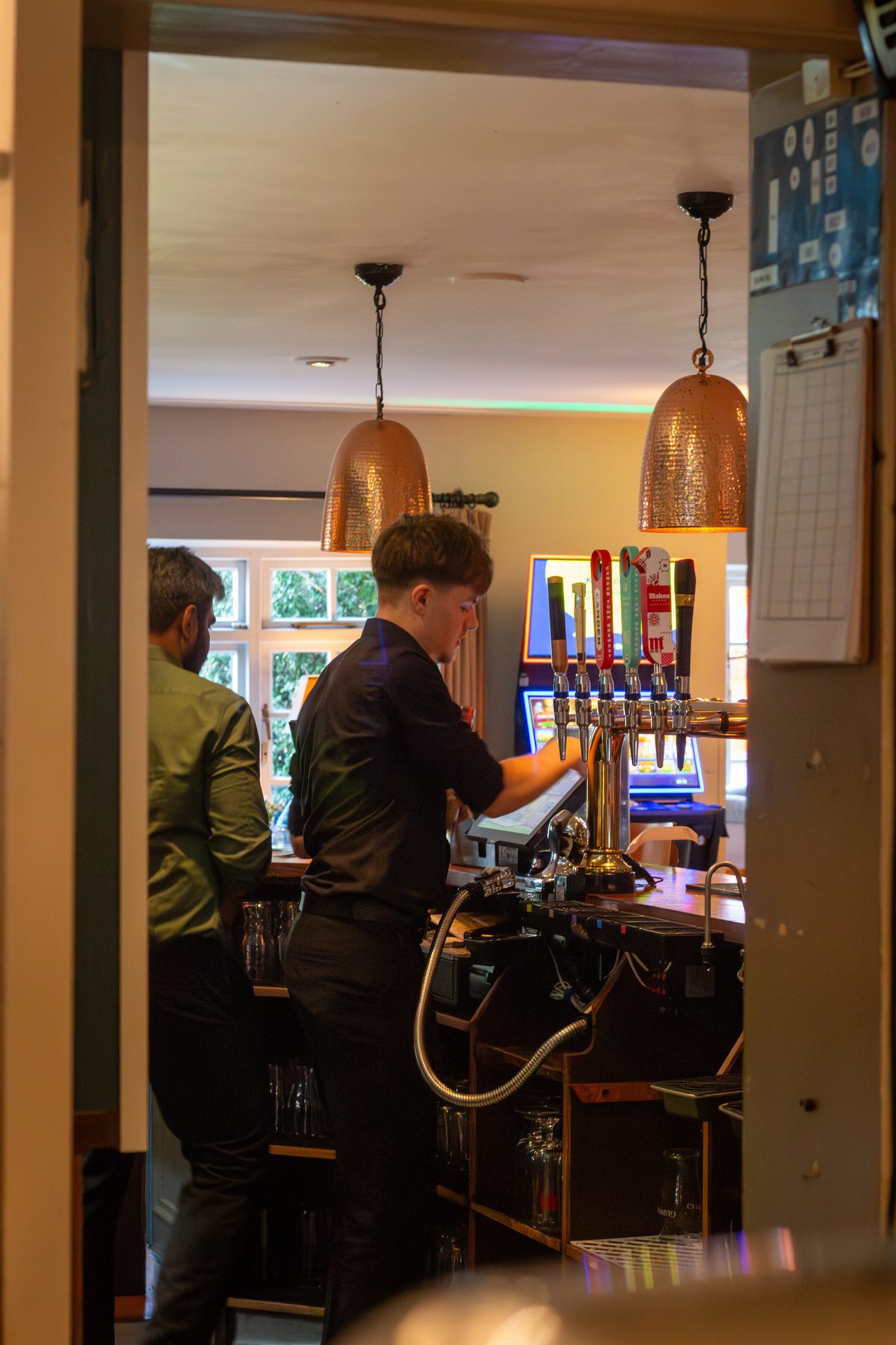 Bar staff pouring craft ales from the taps at The Twisted Boot Bar